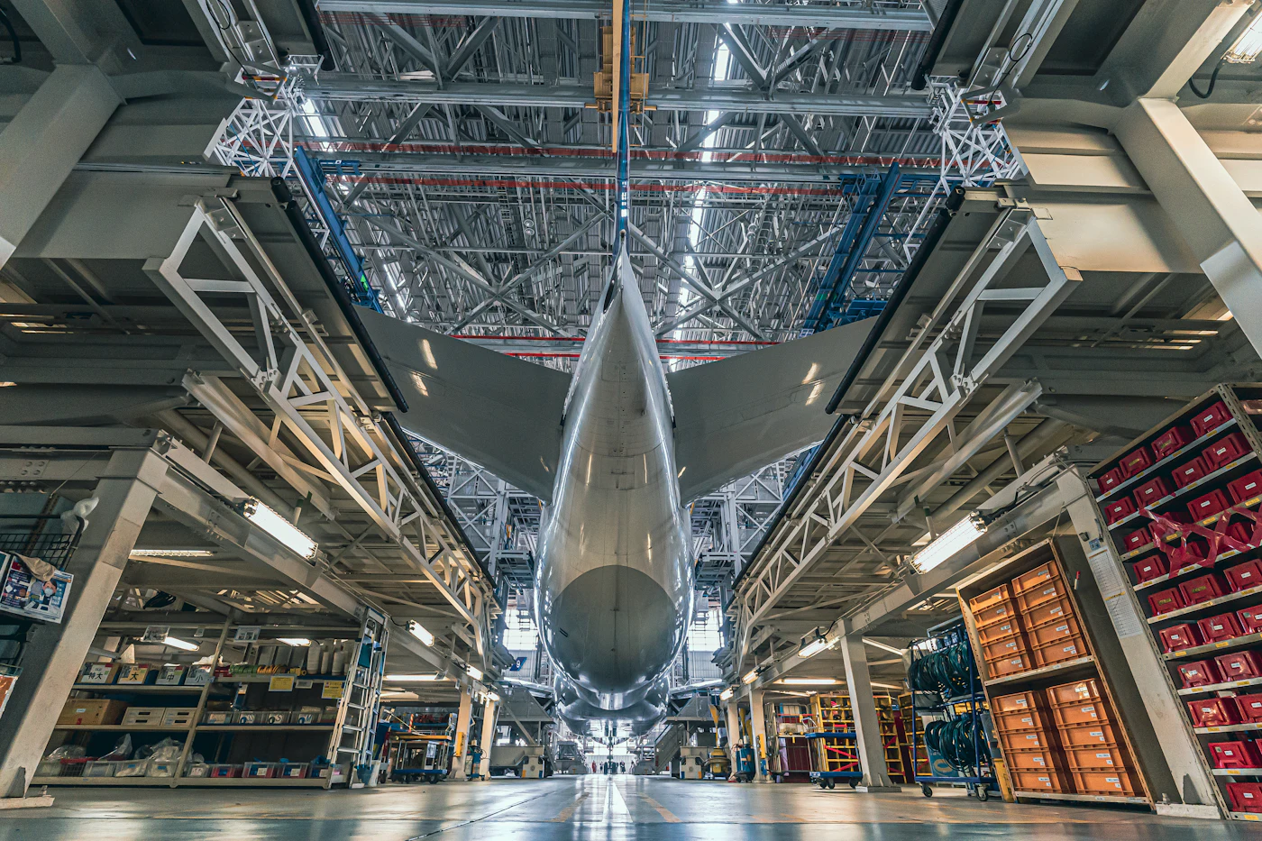 A large aircraft standing as a single body in a hangar