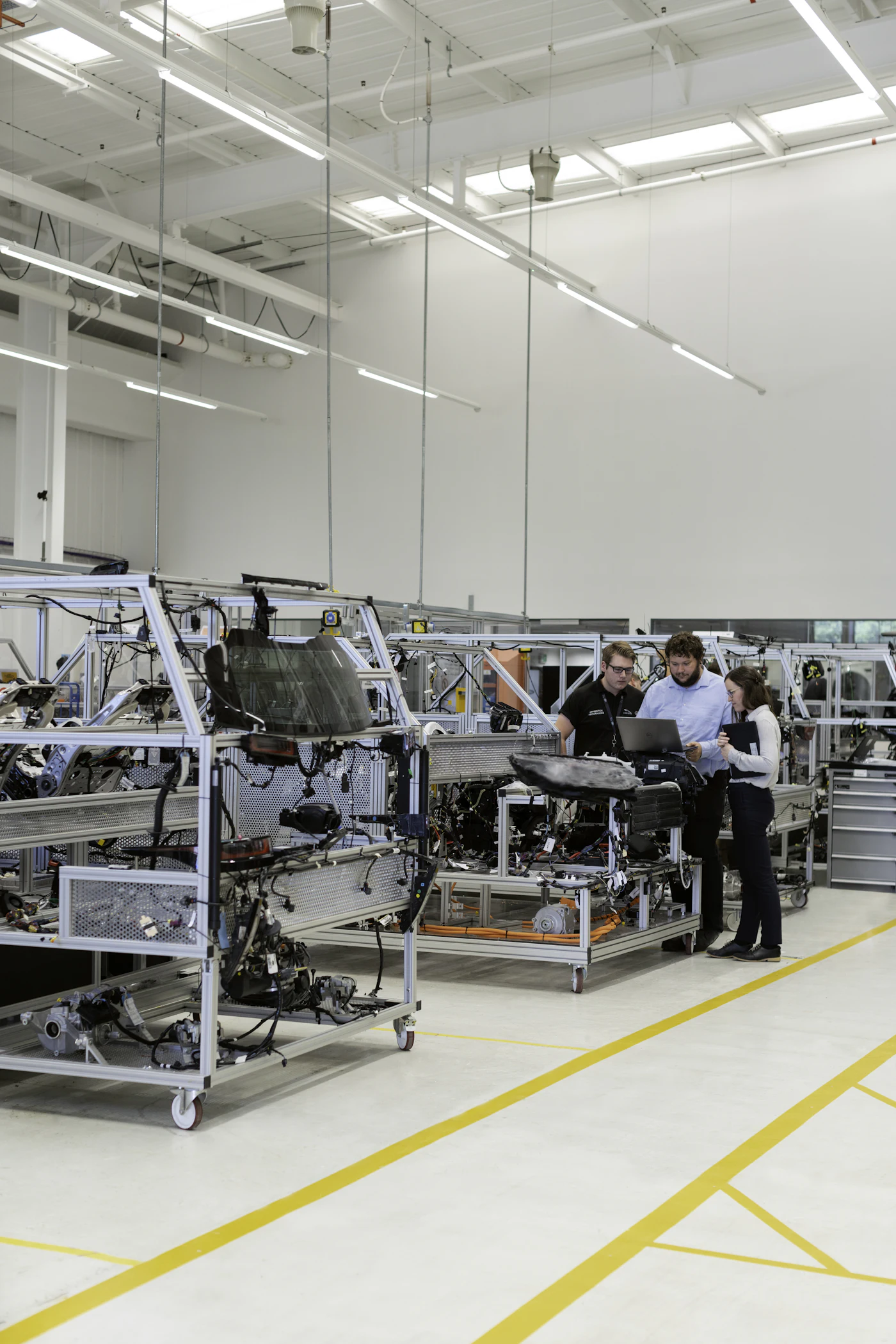 Engineering team working at machines in an industrial production facility